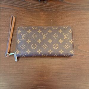 Louis Vuitton Zippy Brown Monogram Wallet with unbranded wristlet strap.